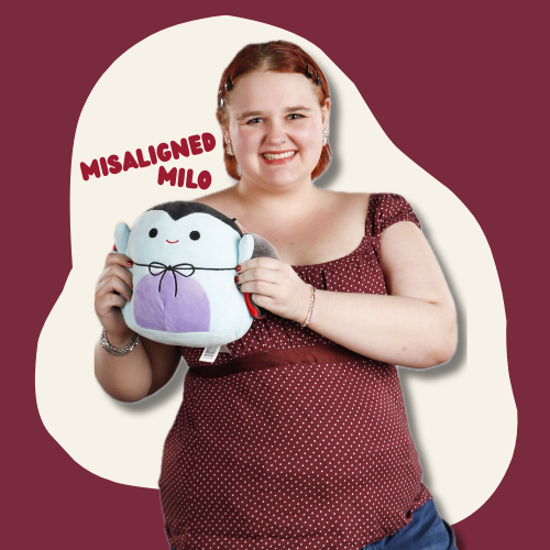 Milo, a feminine white person on a red background holding a Squishmallow and the words "Misaligned Milo" are next to them